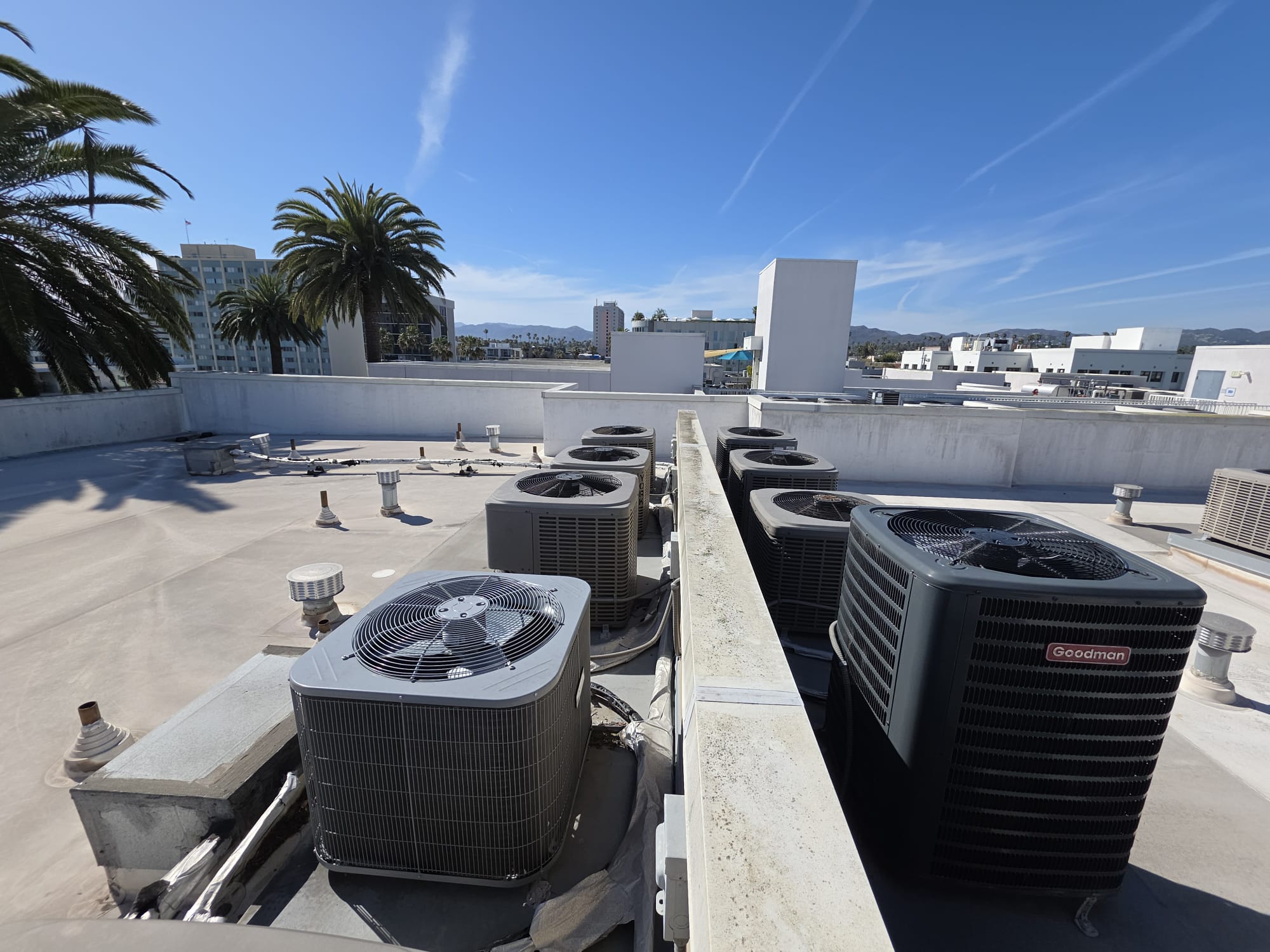 Panoramic rooftop view of multiple residential HVAC units