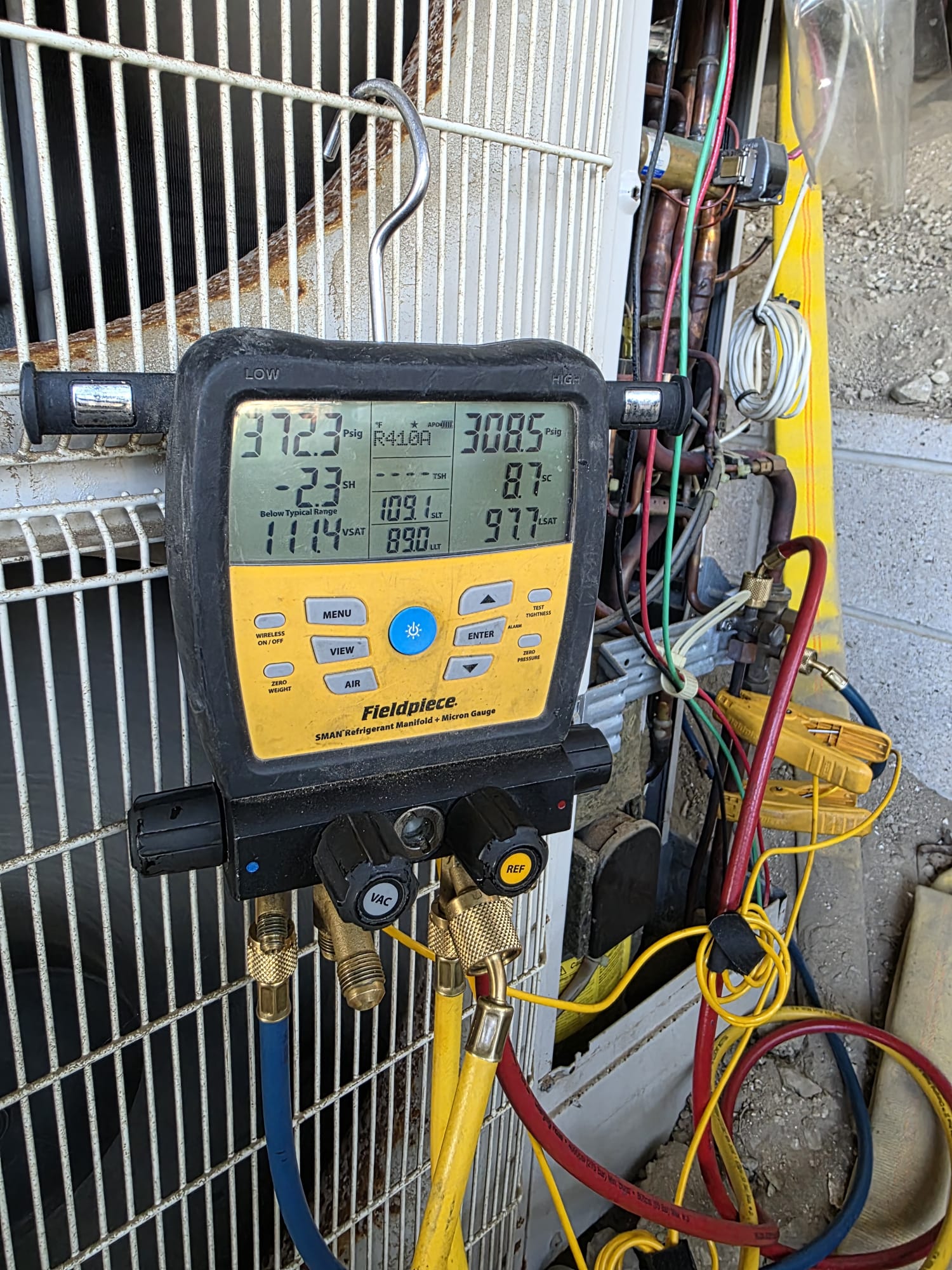 HVAC diagnostic manifold connected to an outdoor air conditioning unit