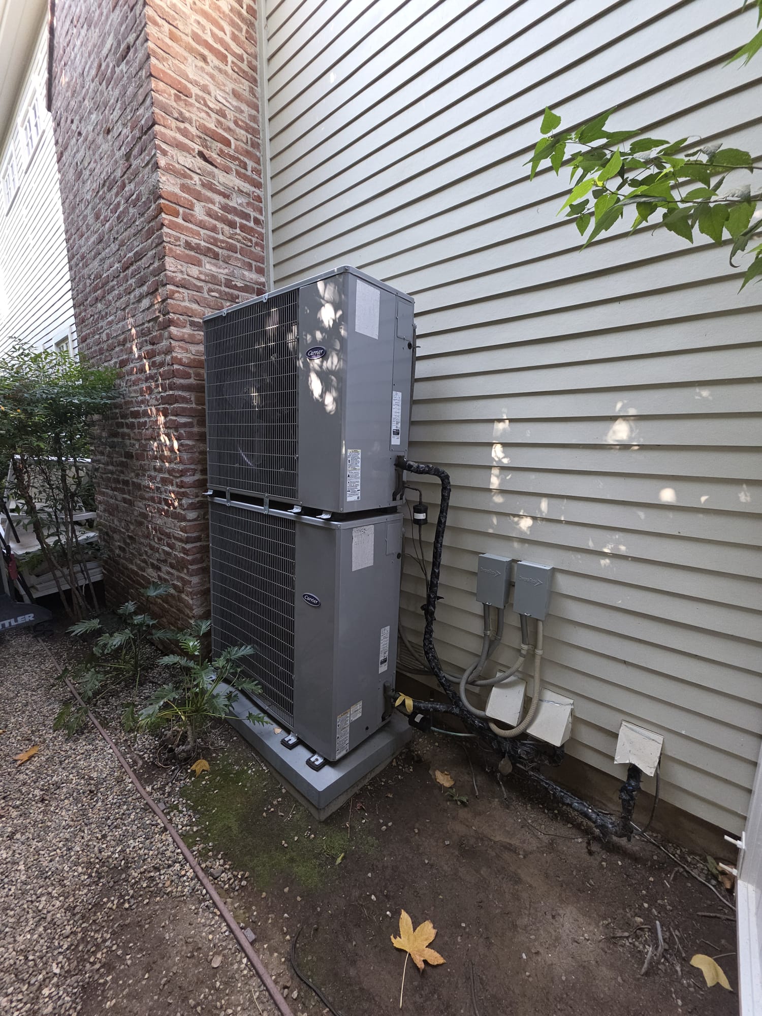 Outdoor residential heat pump installed beside a home