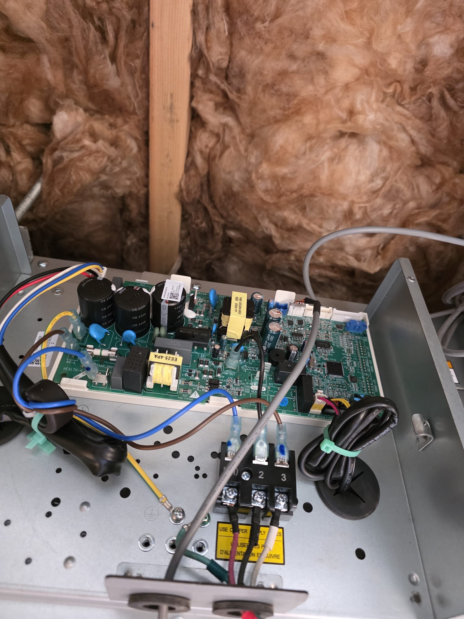 Open residential furnace showing the control board during a heating repair
