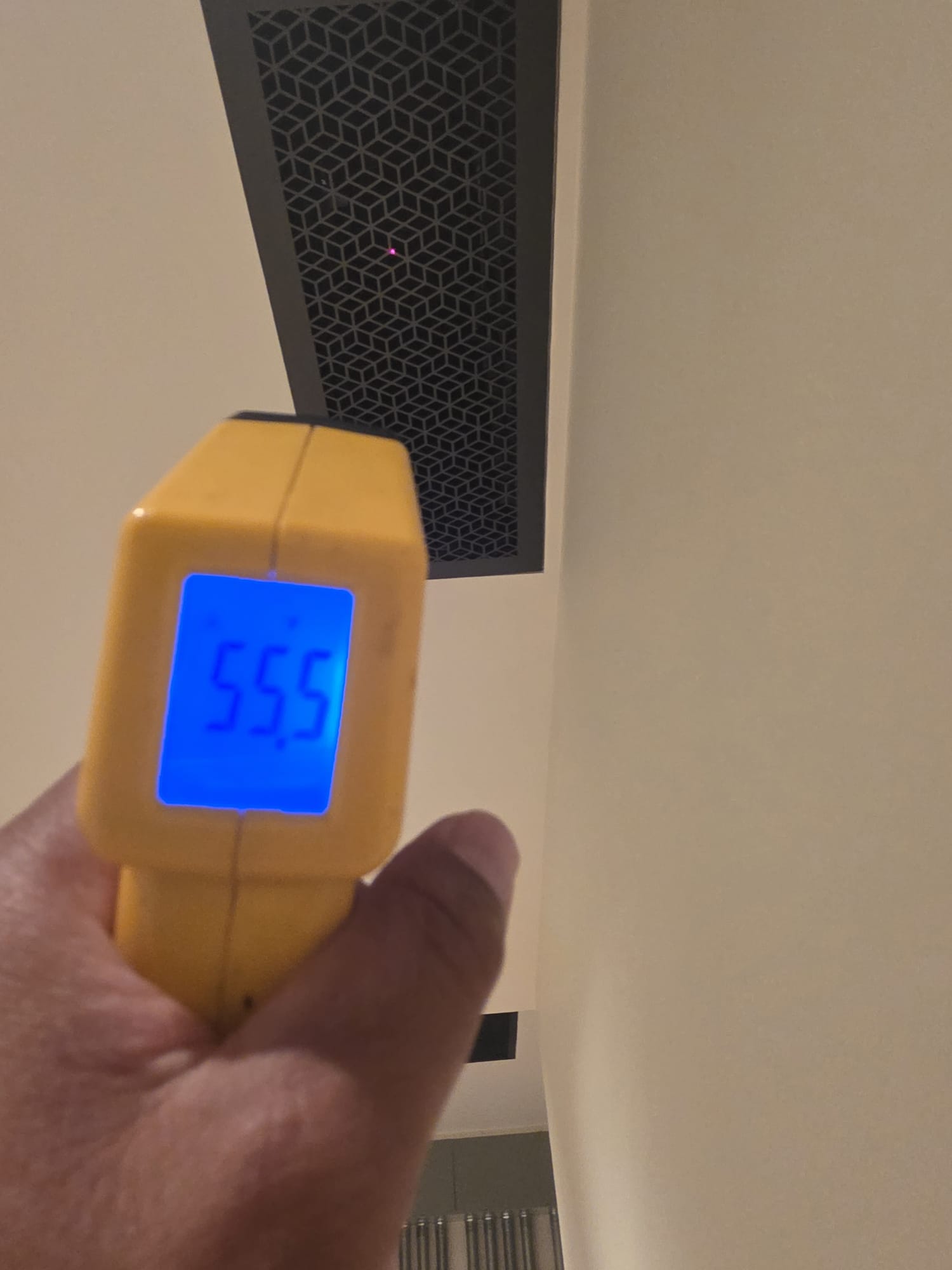 Technician measuring air temperature at a residential supply vent